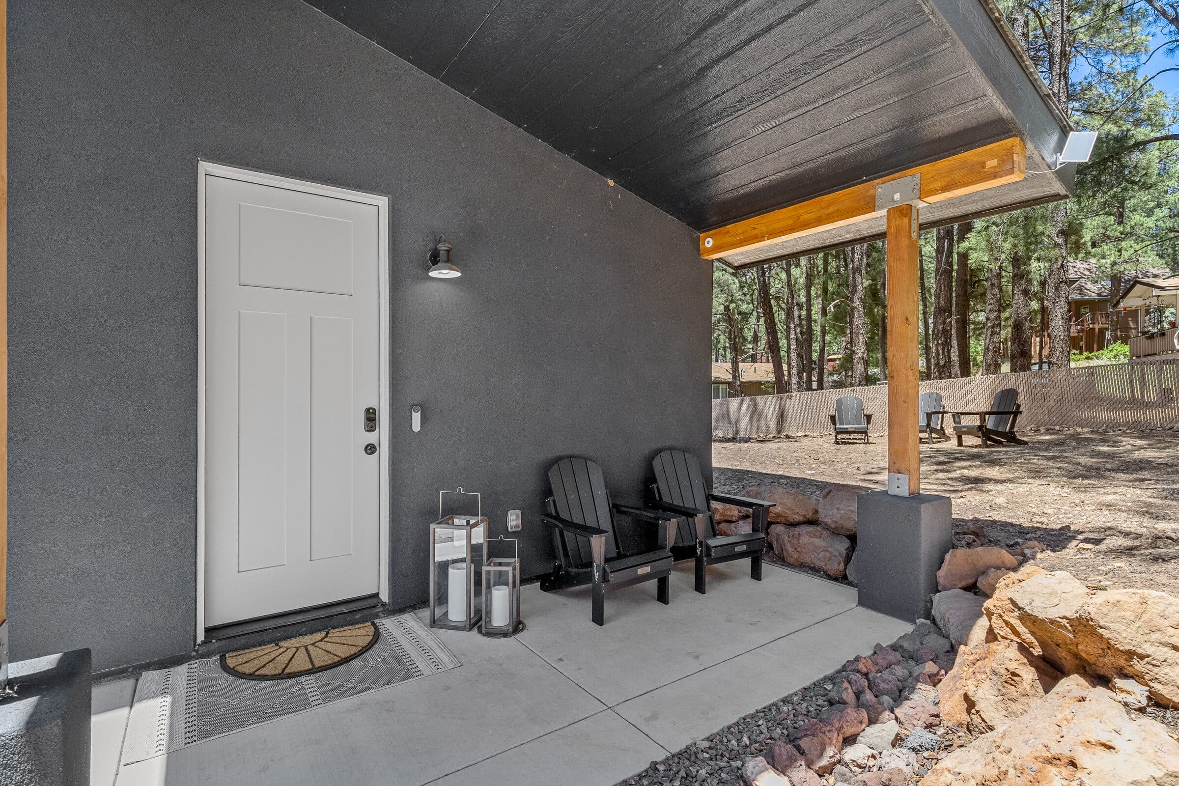 Covered front entry with modern dark siding