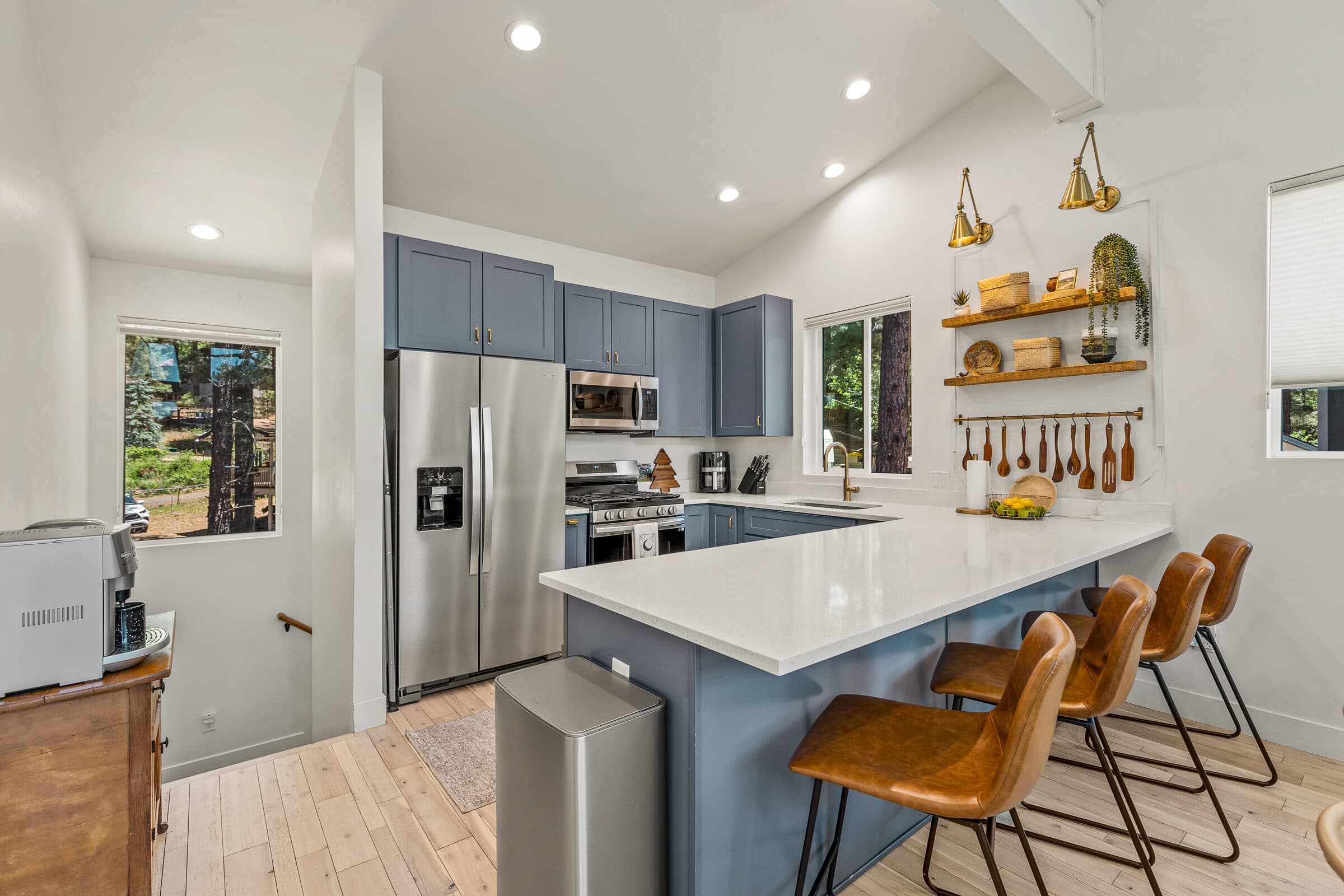 Kitchen island with leather bar stools and stainless appliances