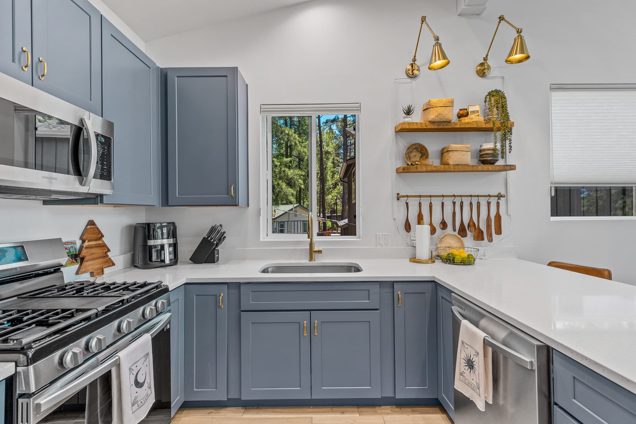 Gas range and prep counter with brass pendant lighting