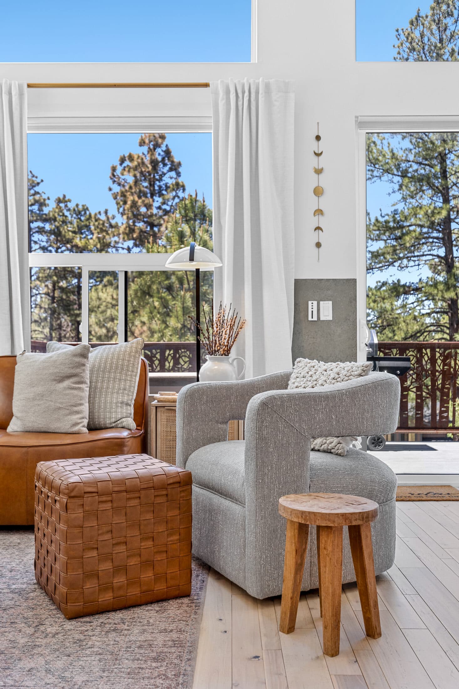 A reading nook with chairs beside a forest-view window