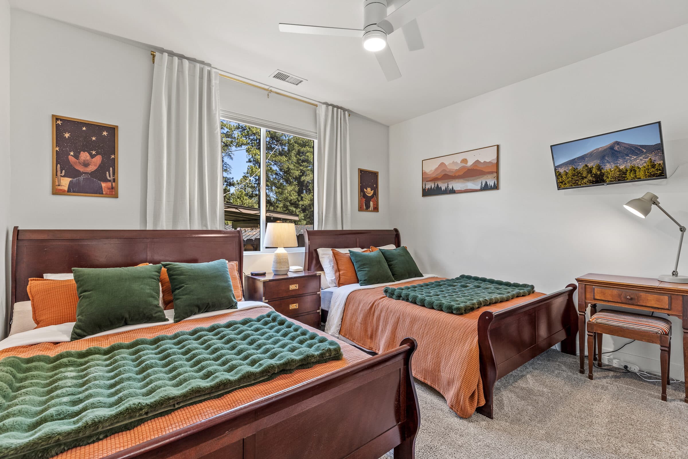 Family room with two beds and framed mountain art