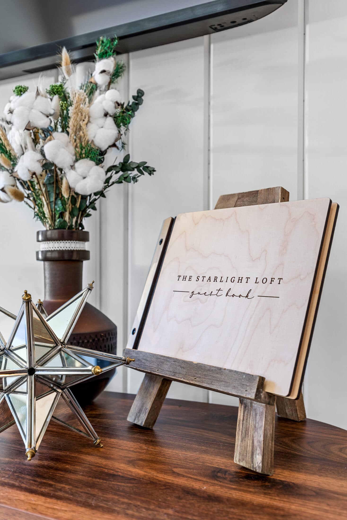 A welcome note and floral arrangement greeting guests