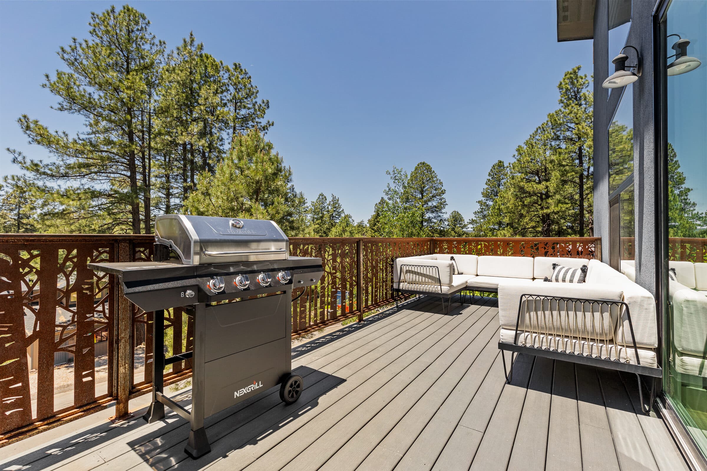 Balcony deck with a grill and views into the ponderosa pines