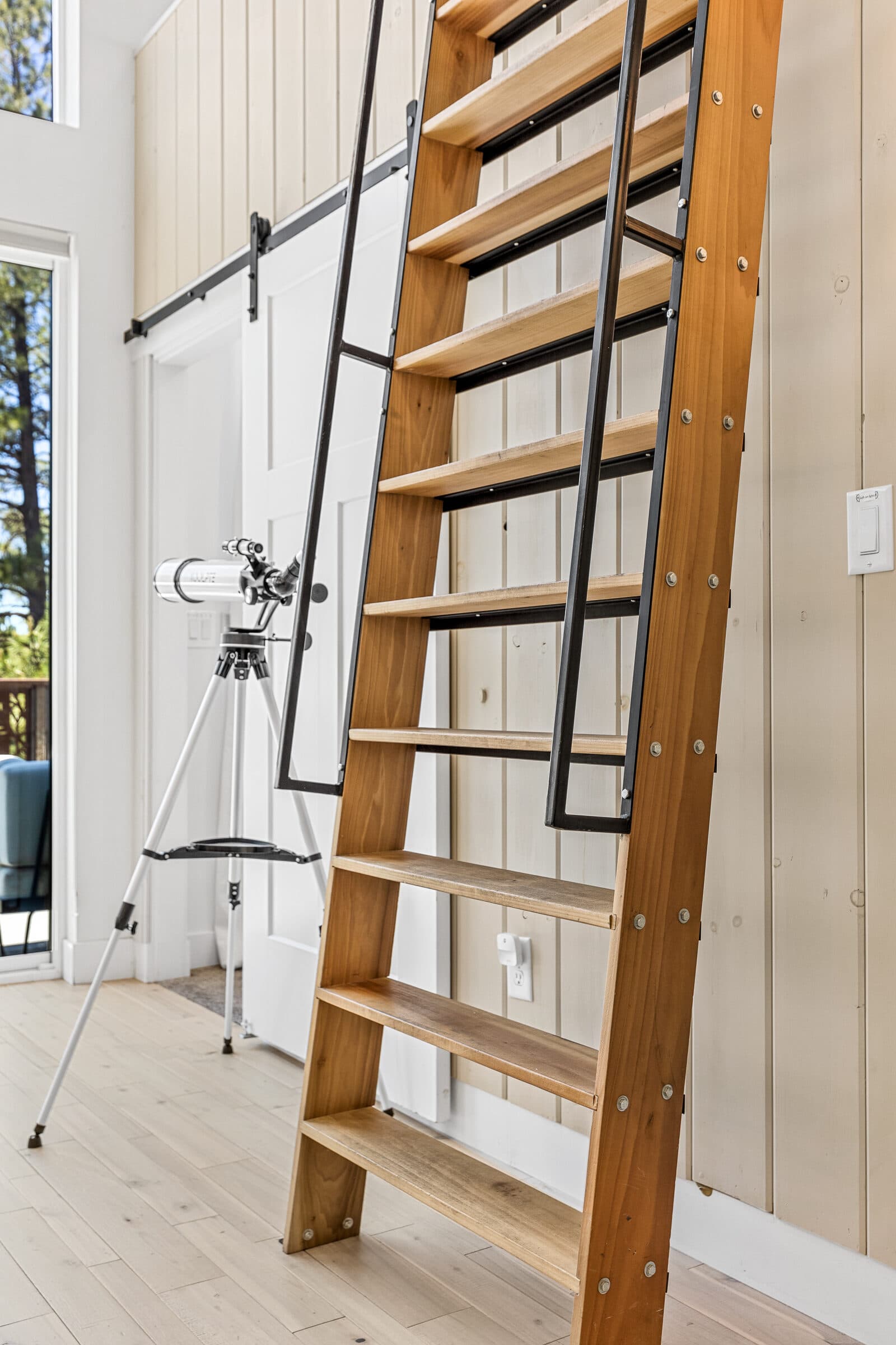 Wood ladder leading up to the guest-favorite loft